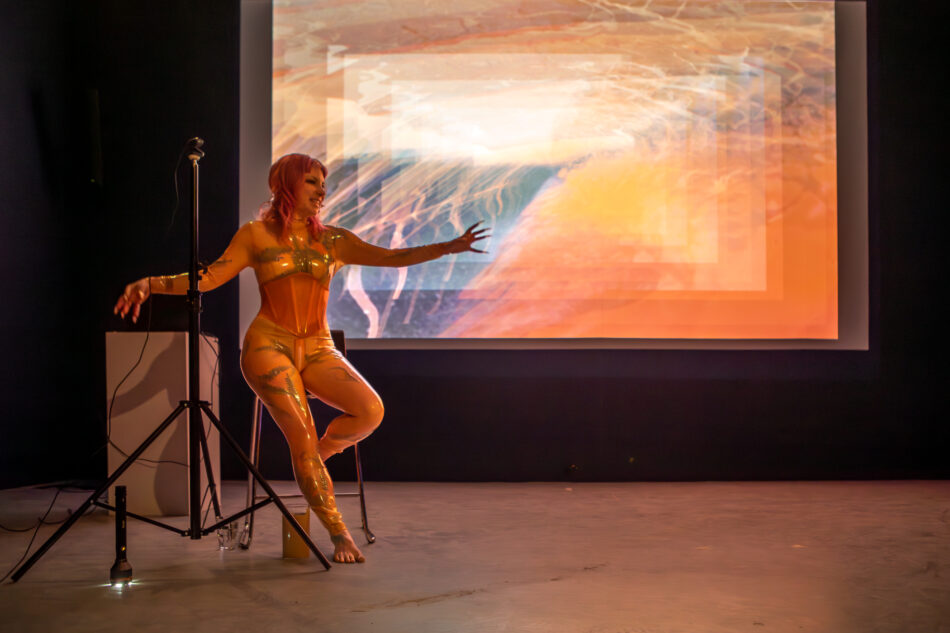 Libby Heaney performs a new iteration of Eat My Multiverse, MU Year's Toast, MU Hybrid Art House, Eindhoven, February 2026. Photo: Hanekke Wetzer.