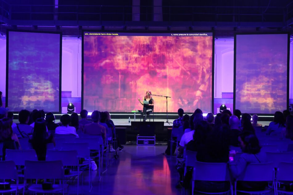Libby Heaney performing slimeQore, 2022, at Immaterial, Tabakalera, San Sebastian, 2025. Photo: Tabakalera.