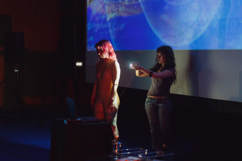 Libby Heaney performing the fourth iteration of Eat My Multiverse at Porto Art School, Porto, 2026. Photo: Miguel De.